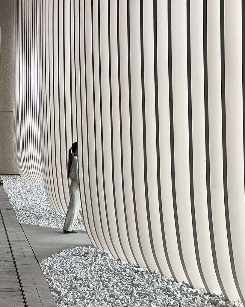 White fa ç ade with undulating hollowing out: Zelini Contemporary Cultural Center